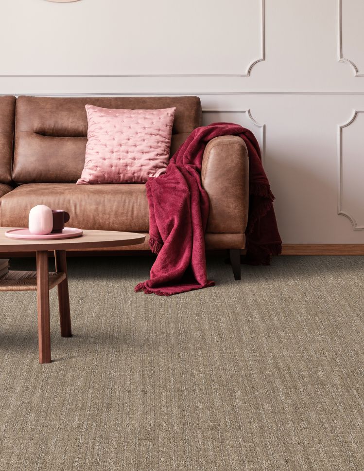 brown textured carpets in a stylish living room with leather couch and pink accents